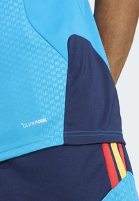 ClimaCool athletic shirt in blue with navy accents, featuring textured patterns and colorful horizontal stripes on the side.