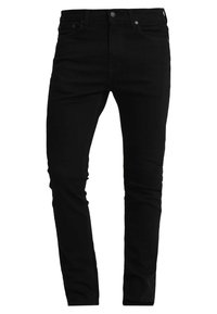 Svarta denimjeans med slim fit, som har fem fickor, dragkedja och metallbeslag. Slät textur och enhetlig färg genomgående.