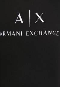 Black cotton T-shirt featuring white graphic text "A|X ARMANI EXCHANGE" with a minimalist design and distinct letter styling.