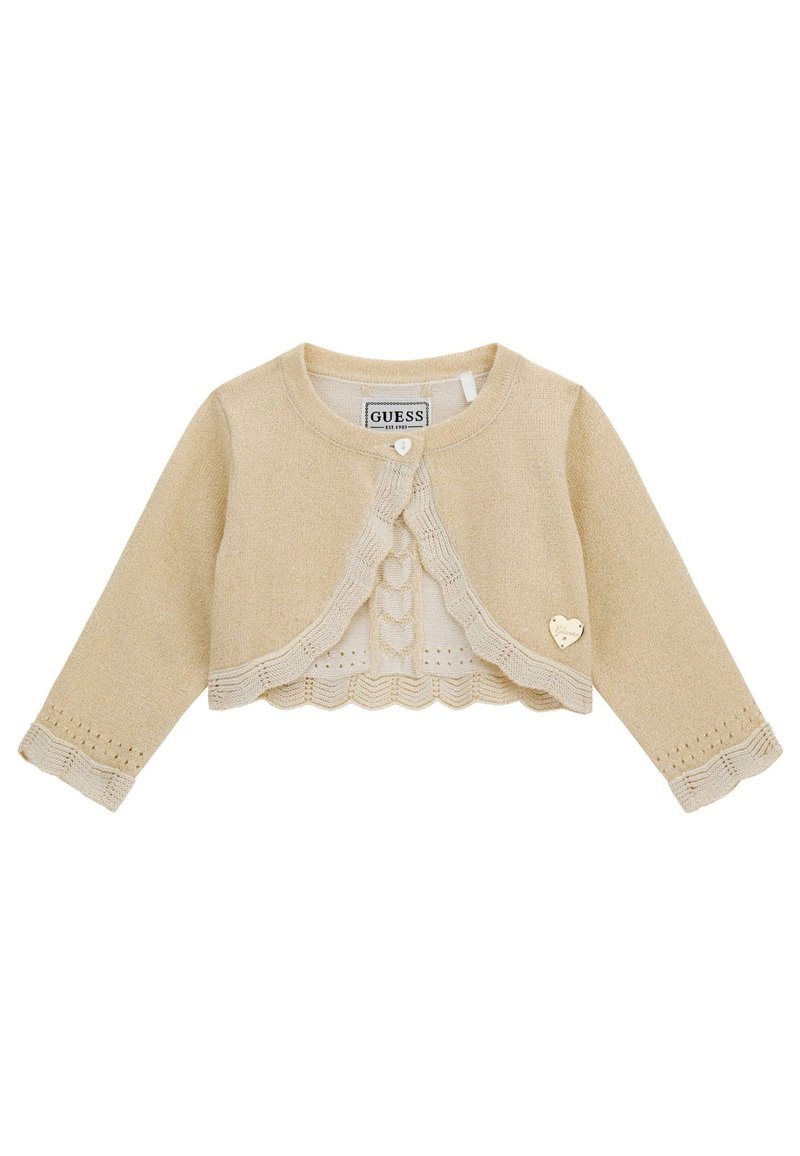 Cardigan a maglia color crema con maniche lunghe, orlo scallop e accent di hardware a forma di cuore. Presenta un motivo testurizzato lungo i polsini.