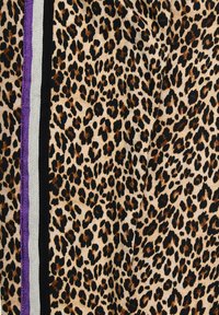 Leopard print fabric with black and gray stripes and a purple accent. Soft texture with varying sizes of black and brown spots on a beige background.