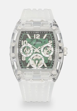 Montre en plastique transparent avec un cadran vert, dotée d'index en argent, de trois sous-cadrans et d'un bracelet en silicone blanc texturé.