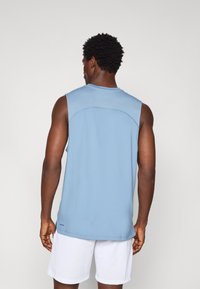 Light blue sleeveless athletic top with a round neckline, smooth texture, and a contrasting mesh panel across the upper back.