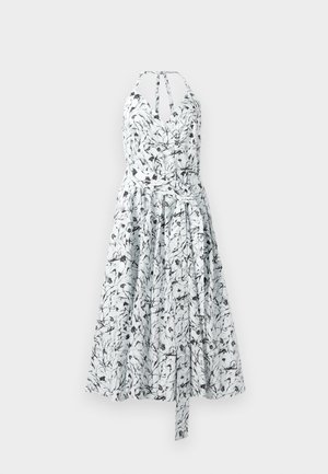 Floral print sundress in white and black, featuring a wrap-style bodice, halter neckline, gathered skirt, and adjustable tie at the waist.