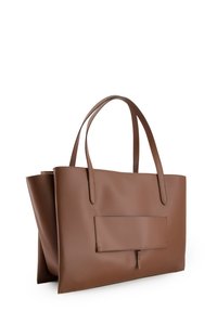 Brown leather tote bag with flat sides, two long handles, and a front pocket. Smooth texture with minimal stitching details.