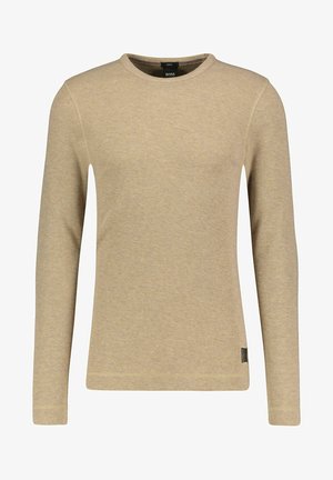 Pull beige à manches longues et col rond en tissu tricoté texturé, avec un patch logo sur le bas côté. Design décontracté et simple.