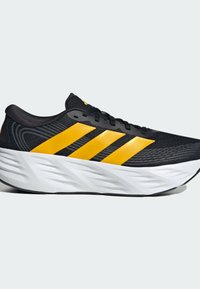 Black running shoe with thick white sole and three yellow stripes on the side, black laces, and textured mesh upper.