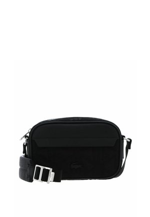 Compact black crossbody bag with adjustable strap and silver buckle, featuring a subtle brand logo on the front.