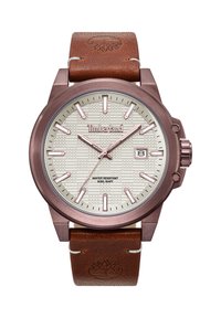 Rudas odinis laikrodis su rožių aukso metaliniu korpusu. Kreminės tekstūros ciferblatas su dideliais žymekliais, datos langu ir Timberland logotipu. Vandeniui atsparus, iki 50 m.