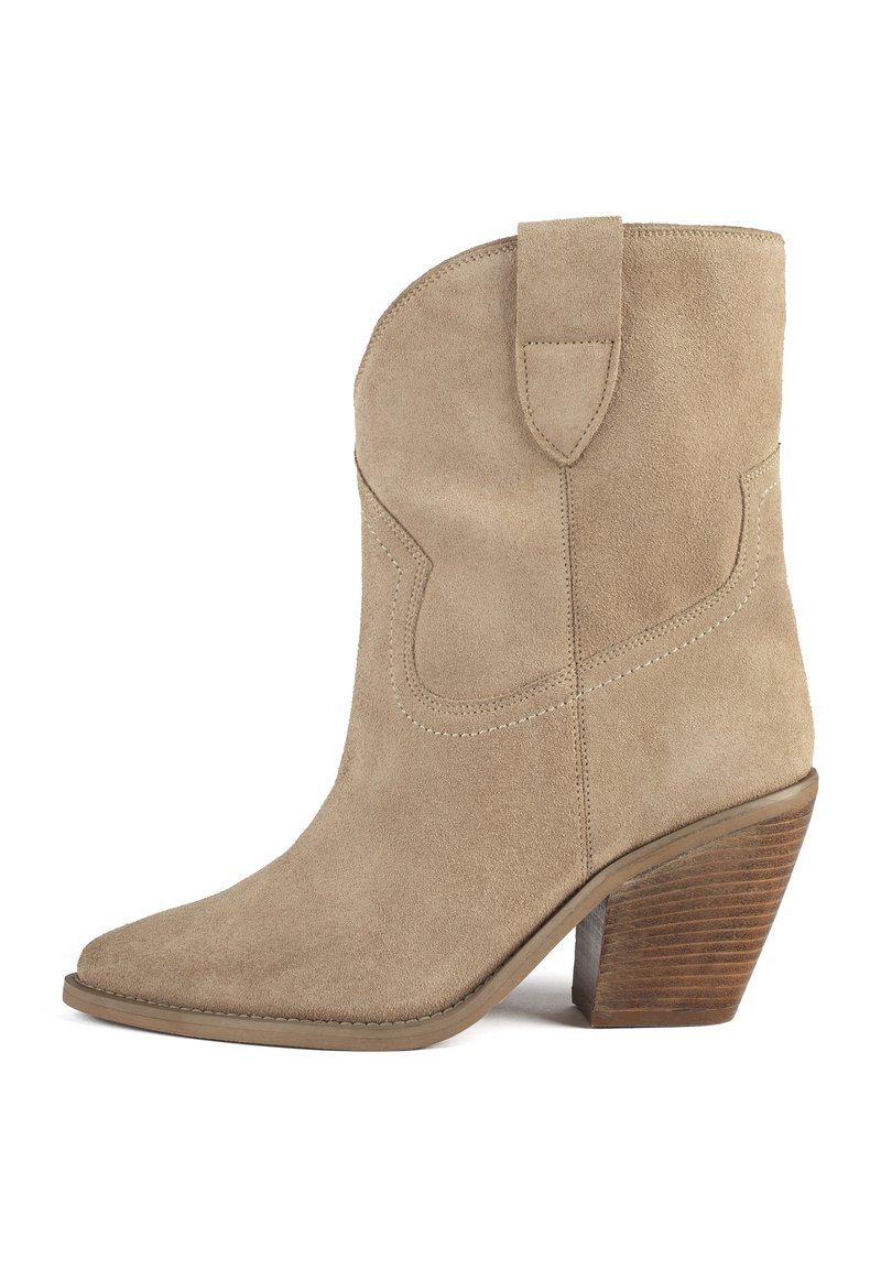 Béžová semišová kotníková bota ve westernovém stylu s špičatou špičkou, dekorativním prošitím, poutkem na zatažení a naskládaným dřevěným blokovým podpatkem.