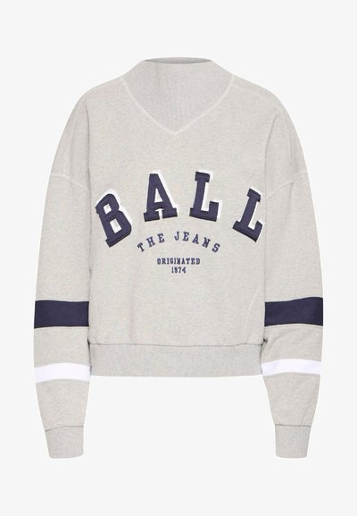 Gray sweatshirt with a V-neck, featuring oversized navy and white letters and stripes on the sleeves. Fabric has a soft texture.