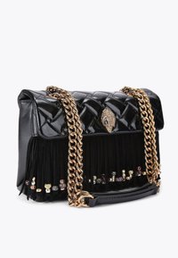 Czarna torebka z pikowanej sztucznej skóry z frędzlami, złotym łańcuszkiem na ramię oraz ozdobnymi elementami u dołu.