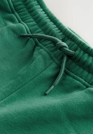 Gröna sweatpants med en mjuk textur, elastisk midja och en flätad dragsko för justerbar passform.