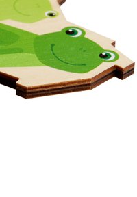 Green wooden frog puzzle piece with a smooth texture, featuring cartoonish faces and round eyes, edged with a darker wood layer.