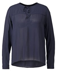 Blouse bleu marine à manches longues en tissu léger, dotée d'un col rond, d'un détail noué à l'avant et d'un ourlet légèrement incurvé.