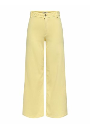 Spodnie o wysokim stanie i szerokich nogawkach w pastelowym żółtym kolorze, z szlufkami na pasek, zapięciem na guziki z przodu oraz przeszyciami wzdłuż nóg.