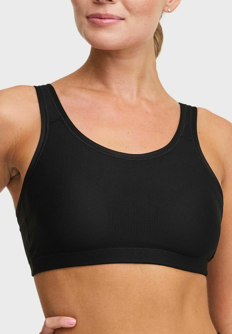 Svart sportbh i texturerad tyg med rundad halsringning och breda axelband för stöd. Enkelt design utan synliga knäppningar.