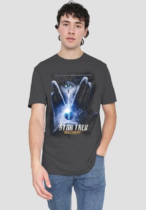 Dark gray t-shirt featuring a graphic print of a hand framing an eye with a starry background and "Star Trek Discovery" text at the bottom.