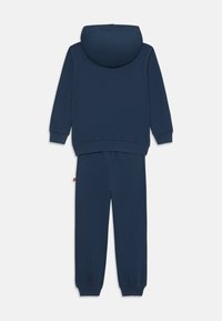Navyblaue Sweatshirt- und Jogginghose aus weichem Stoff. Mit Kapuze, gerippten Bündchen und elastischem Bund. Einfaches Design, keine Muster.