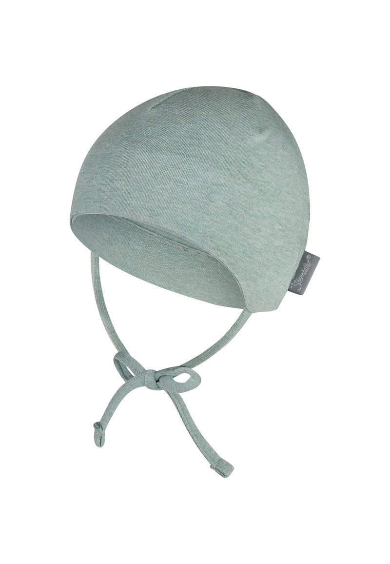 Cotton baby cap in light green with rounded top, tie straps for securing, and small tag on side. Soft, stretchy texture, seamless design.