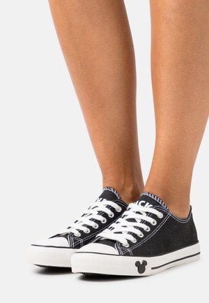 Černé plátěné tenisky s bílými tkaničkami a bílou podrážkou, na boku s malou siluetou Mickey Mouse.