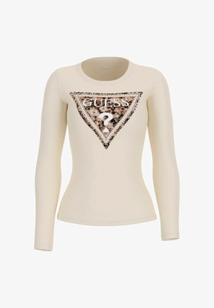 Top beige a maniche lunghe aderente con un grande logo triangolare Guess decorato con stampa leopardata e dettagli in strass sul petto.