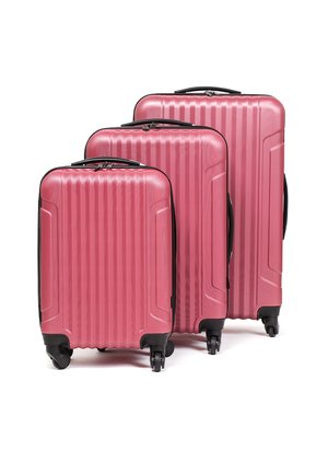 Set of three pink hard-shell suitcases with vertical ribbed texture, black corners, zippers, and four wheels for mobility.