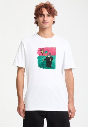 White short-sleeve t-shirt featuring a colorful graphic of a character with a spiky sun and a tree on a green background.