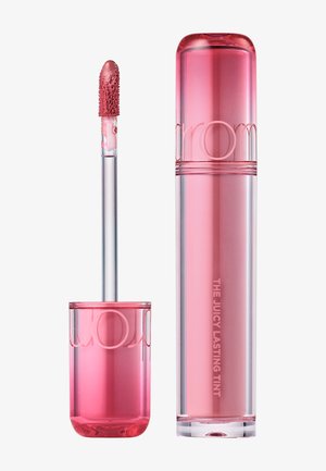 Różowa tubka z barwnikiem do ust z aplikatorem, aplikator pokryty połyskującym różowym płynem, oznaczona jako "The Juicy Lasting Tint".