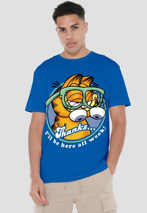 Blue cotton T-shirt featuring a cartoon character with large eyes and glasses, accompanied by the text "Thanks... I'll be here all week!"