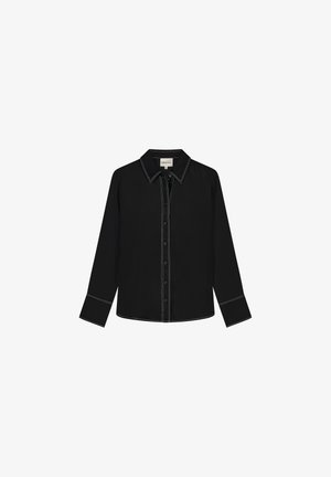 Black long-sleeve shirt in lightweight fabric, featuring a pointed collar, button-down front, and contrasting white stitching along seams.