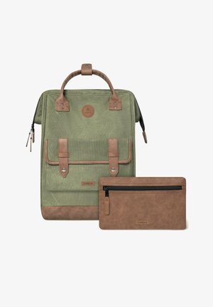Green fabric backpack with brown leather accents and straps. Features a top handle, zip closure, and a matching flat zippered pouch.