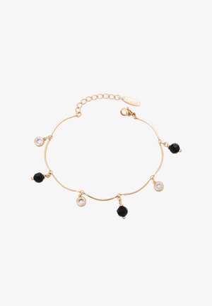 Kultaketjuinen rannekoru, jossa on neljä roikkuvaa elementtiä: kaksi mustaa helmeä ja kaksi kirkasta kristallikoristetta, joka on varustettu rapukoukkukiinnityksellä.