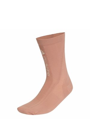 Lysebrun mellemlang sok med ribbet tekstur og hvidt logo tekst "STELLASPORT" langs siden, vist fladt mod hvid baggrund.