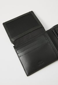 Black leather wallet with a smooth texture, featuring multiple card slots, a transparent ID holder, and subtle branding on the inner surface.