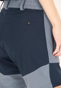 Navy och grå färgblock shorts med elastisk midja och fickor. Har en liten logotypdetalj på bakfickan. Lättviktig tyg.