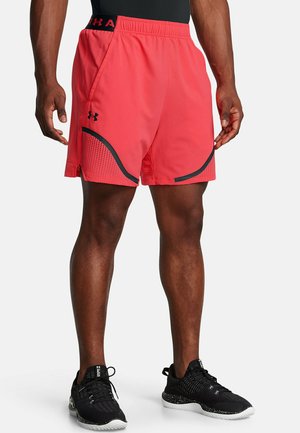 Red athletic shorts with black accents, featuring a breathable mesh panel and an elastic waistband. Worn with black training shoes.