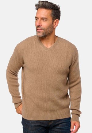 Pull en maille côtelée beige avec un col en V, des manches longues et un tissu texturé. Design décontracté adapté à la superposition.