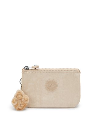 Beige pouch made of soft material, featuring a textured surface and a circular logo. Includes a plush monkey keychain attached by a metal clip.