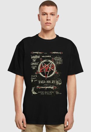 Black T-shirt with a graphic print featuring "Slayer," event details, and a skull design. The print combines bold red and white text on a distressed background.
