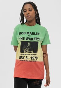 Green to yellow to red gradient t-shirt featuring black text and an image of Bob Marley. Round neck and short sleeves.