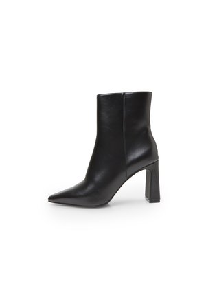 Black leather ankle boot with a pointed toe and a block heel. Smooth texture and clean design with a minimalist silhouette.