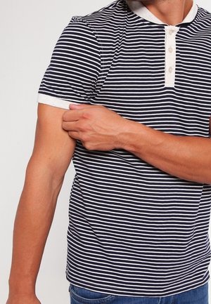 Marineblå og hvide stribede polo med kontrastkrave, tre-knaps lukning og korte ærmer, der viser et figursyet design.