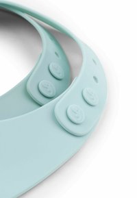 Heledad sinine silikoonkaelarihm, ümarate servadega, millel on kolm nuppu reguleerimiseks. Sile tekstuur, minimalistlik disain.