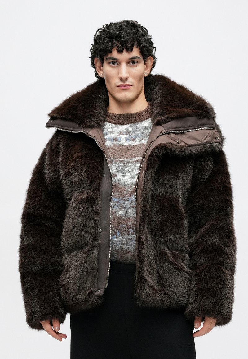 Brown faux fur jacket with a detachable hood, padded design, and zippered front. Textured fabric and plush collar provide warmth.