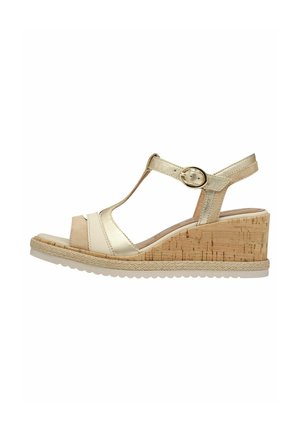 Gold and beige wedge sandal with a cork heel, T-strap design, adjustable buckle, and textured footbed. Sole is white and patterned.