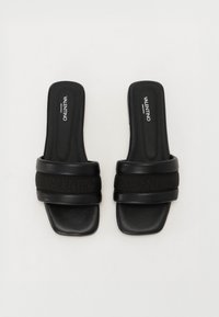 Black slide sandals with two wide straps, featuring embossed branding. Smooth texture with a flat sole and rounded edges.