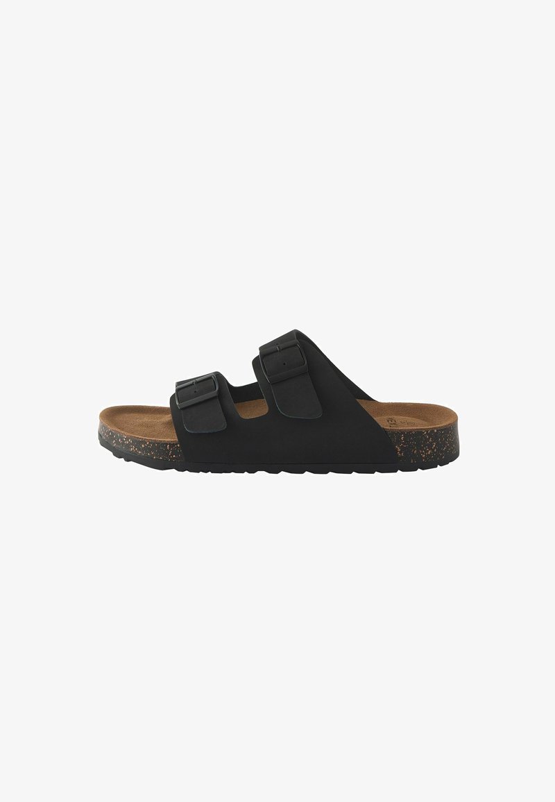 Black slide sandal with two adjustable straps, cork footbed, textured rubber sole, and a smooth upper material.
