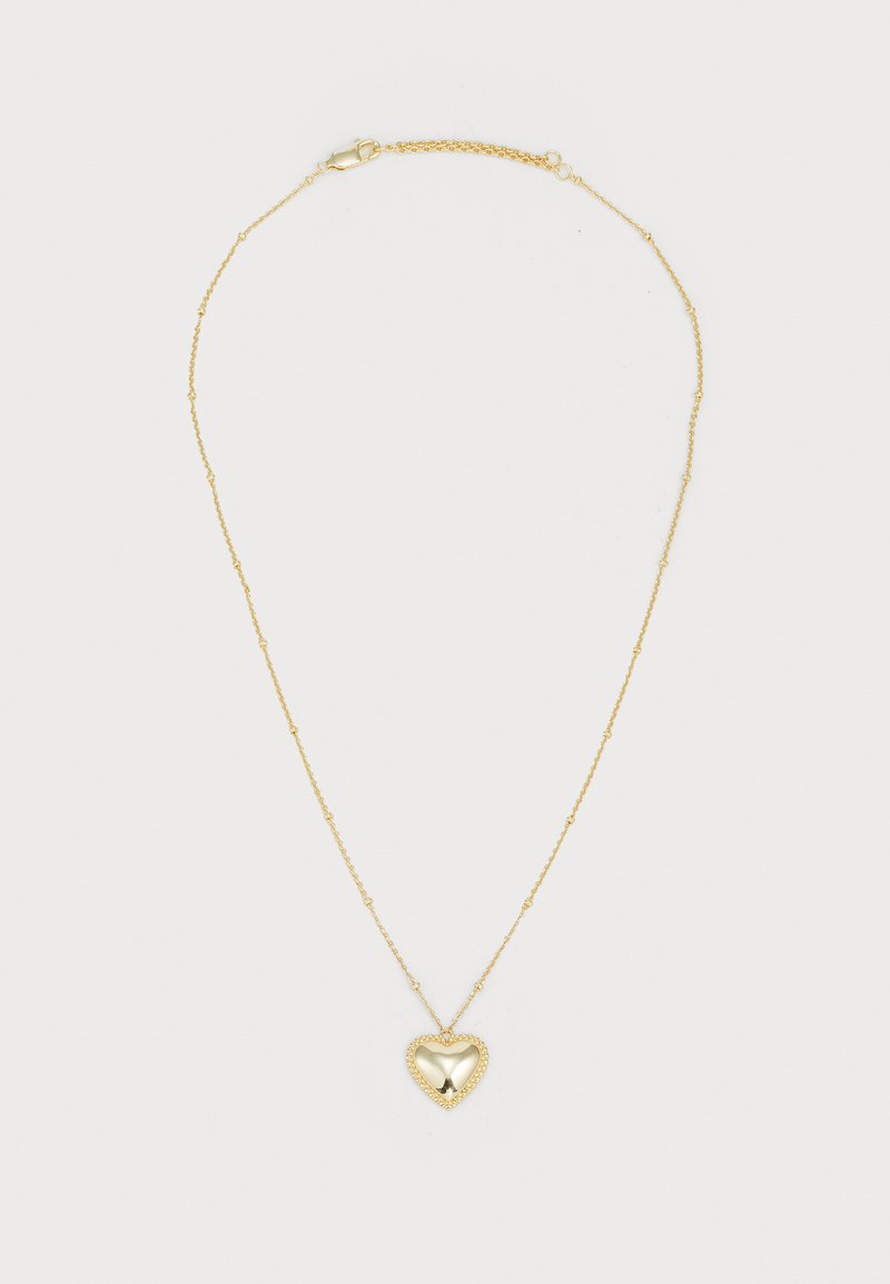 Colar de ouro com uma corrente delicada. Pingente em forma de coração com uma superfície lisa, borderado por pequenas contas. Fecho ajustável na parte de trás.