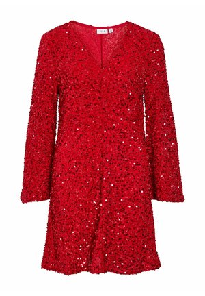Robe rouge à manches longues, décolleté en V, en tissu texturé couvert de sequins, créant une surface scintillante. Longueur courte, coupe décontractée.